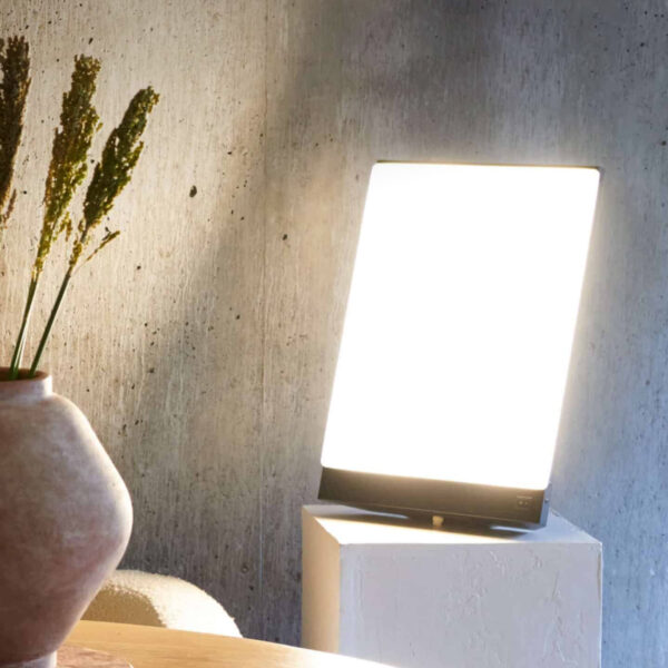 BOXelite Desk Lamp providing bright light therapy in a modern living space